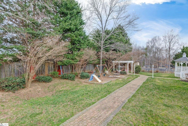 view of yard featuring a gazebo, a playground, a fenced backyard, and a pergola