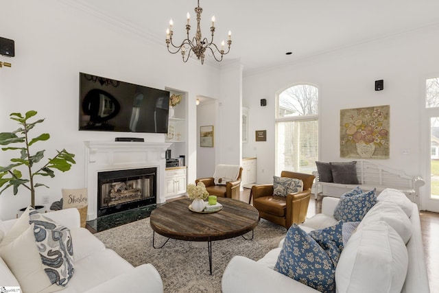 living room with a fireplace and crown molding