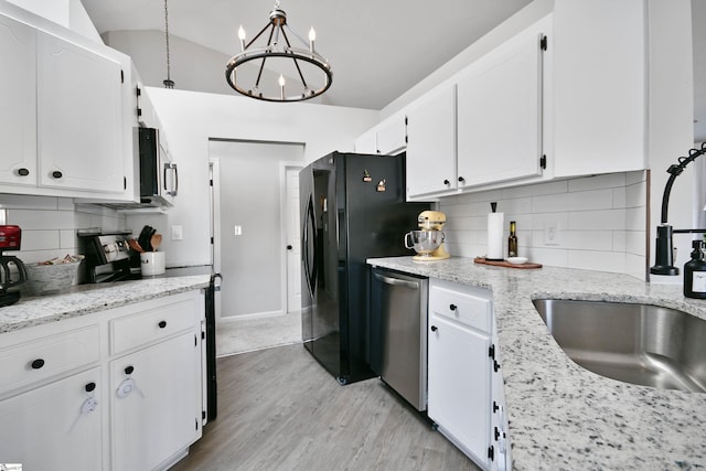 kitchen with appliances with stainless steel finishes, light wood-type flooring, a sink, and white cabinetry