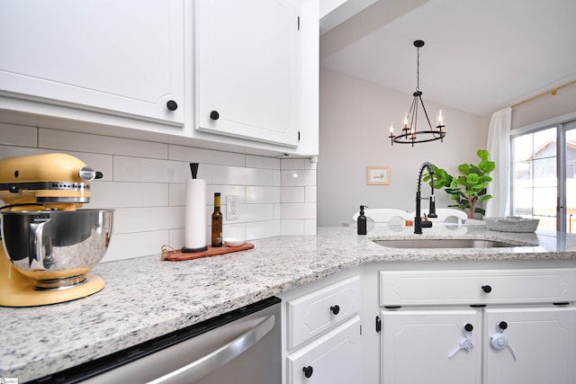 kitchen featuring a sink, white cabinetry, vaulted ceiling, dishwasher, and tasteful backsplash