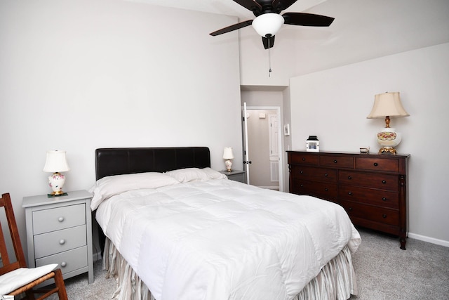 bedroom featuring a ceiling fan, light carpet, and baseboards