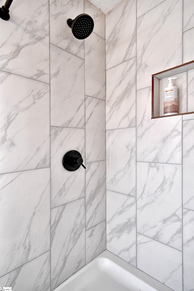 bathroom with tiled shower