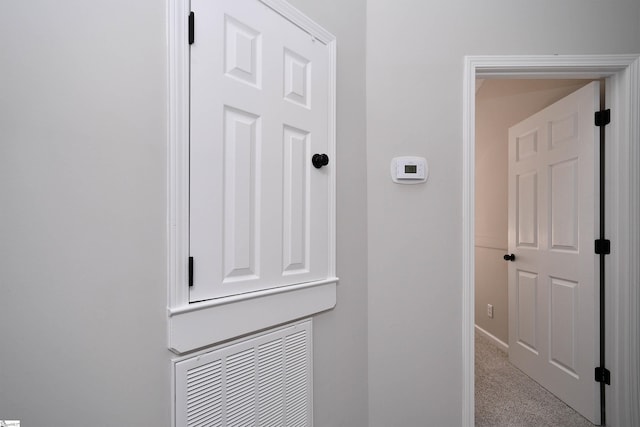 hallway with carpet flooring and baseboards