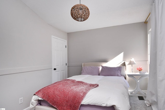 carpeted bedroom featuring visible vents