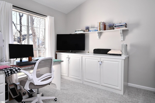 carpeted home office with lofted ceiling