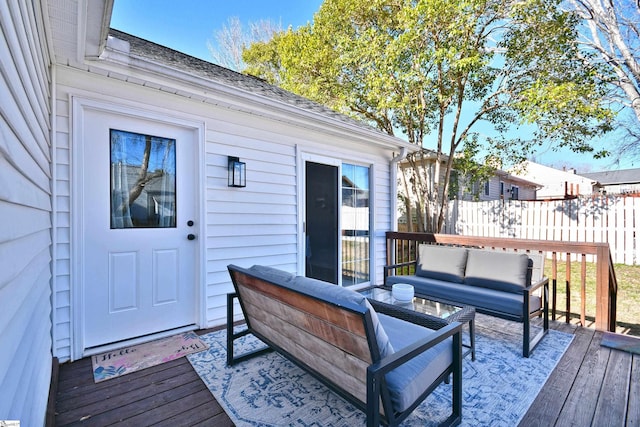 wooden deck featuring outdoor lounge area and fence