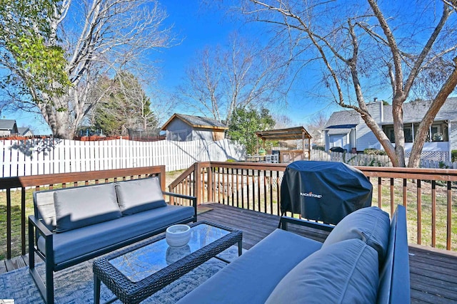 wooden terrace with fence private yard, a grill, and an outdoor living space