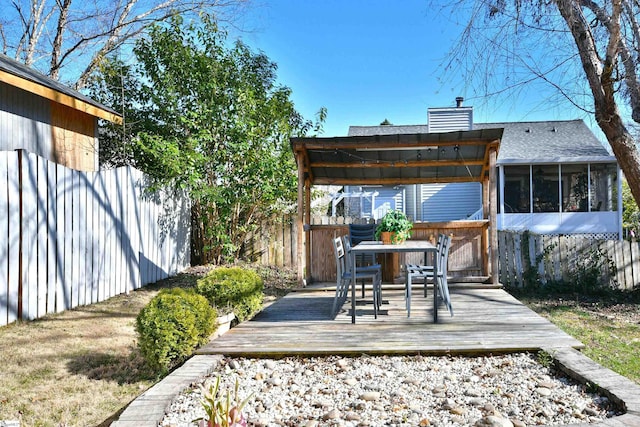 view of patio with a sunroom, fence, and a deck