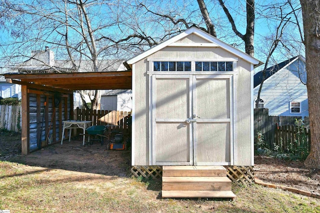 view of shed featuring fence