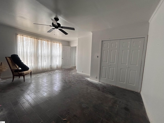 unfurnished room with crown molding, ceiling fan, dark wood-type flooring, and baseboards