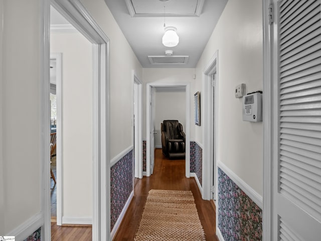 hall with attic access and wood finished floors