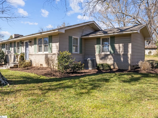 view of front of property with brick siding, central AC unit, a chimney, crawl space, and a front yard