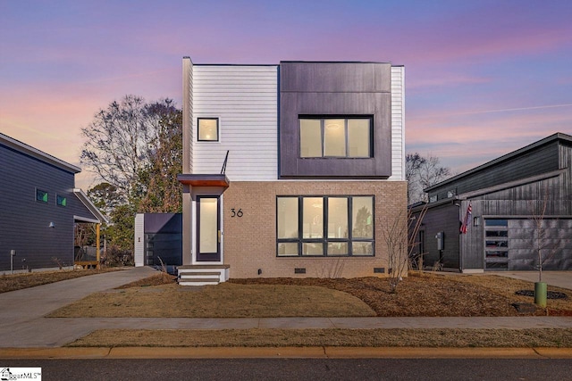 modern home with a garage, entry steps, crawl space, and driveway