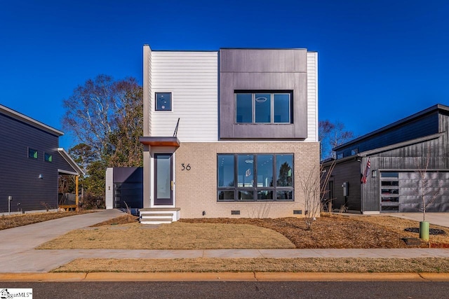 contemporary house featuring a garage, driveway, crawl space, and entry steps