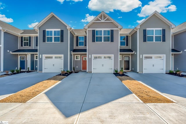 view of property featuring driveway and an attached garage