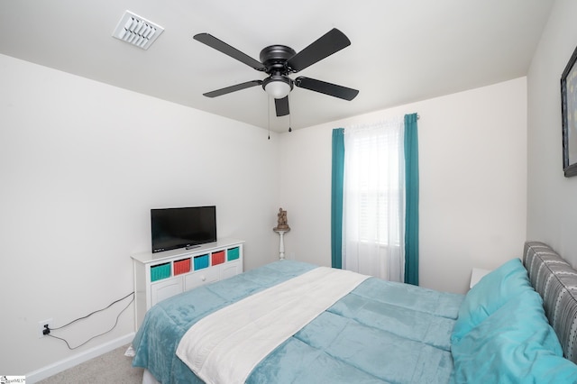 bedroom featuring a ceiling fan, baseboards, visible vents, and carpet flooring
