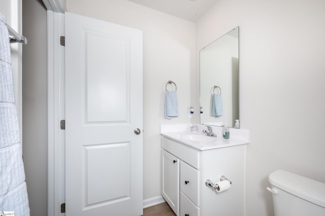 bathroom featuring vanity and toilet