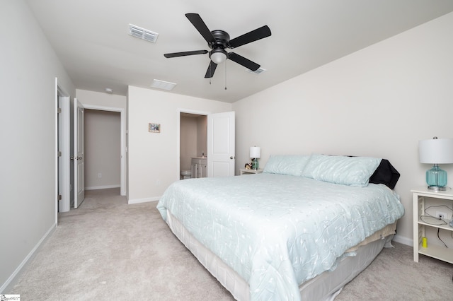 bedroom with light carpet, ceiling fan, visible vents, and baseboards
