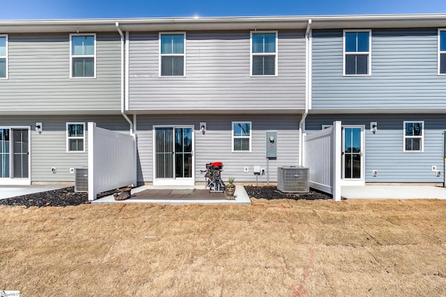 back of property featuring a yard, cooling unit, a patio, and fence