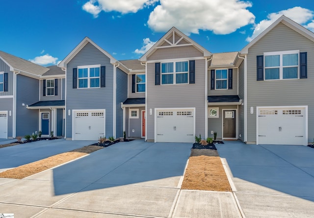 view of property featuring driveway and an attached garage