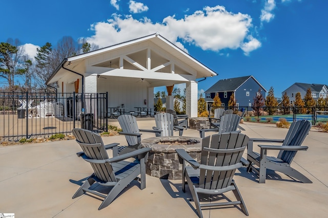 view of patio featuring fence and a fire pit