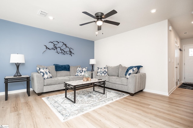 living area with recessed lighting, light wood-type flooring, visible vents, and baseboards