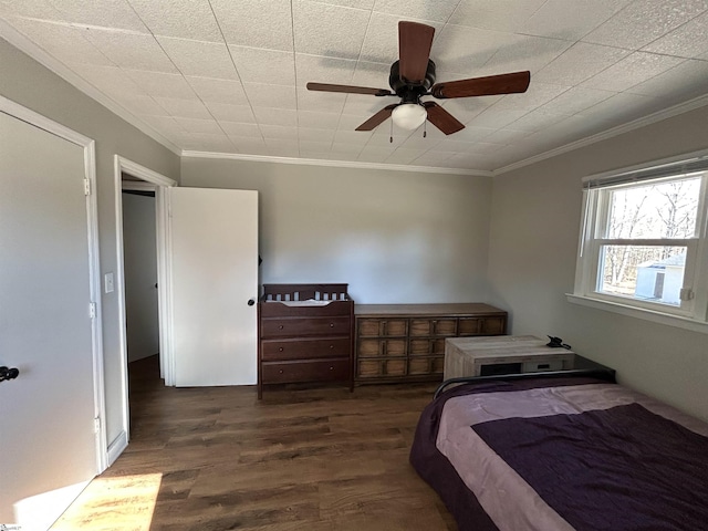 bedroom with ornamental molding, ceiling fan, and wood finished floors