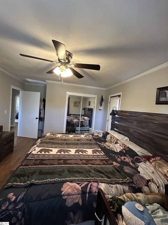 bedroom with ceiling fan, crown molding, and wood finished floors