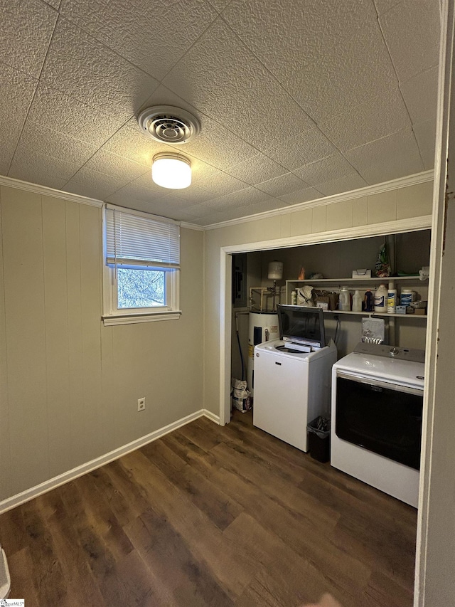 clothes washing area featuring laundry area, washer and clothes dryer, visible vents, and dark wood-style flooring