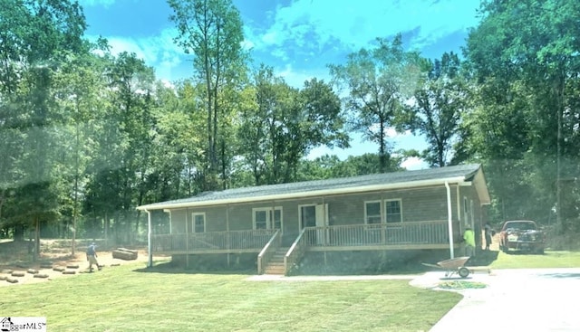 view of front of property featuring a porch, stairway, and a front yard