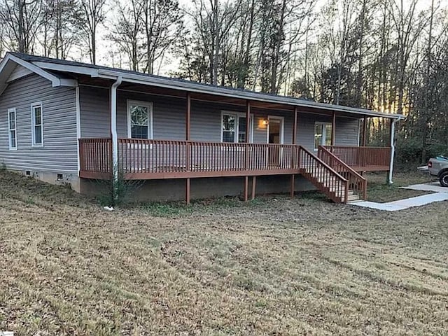 ranch-style house featuring a porch, a front yard, and crawl space