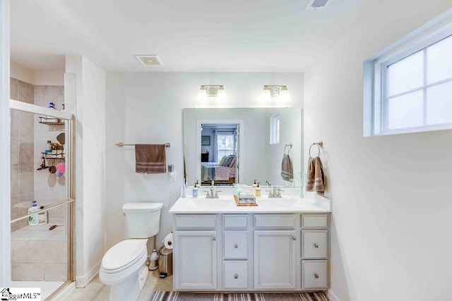 ensuite bathroom with ensuite bathroom, plenty of natural light, a shower stall, and visible vents