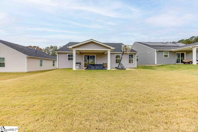 rear view of house featuring a lawn