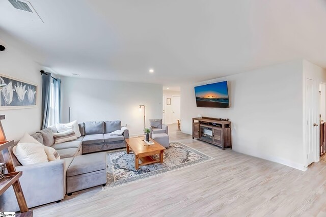 living room with recessed lighting, visible vents, and light wood-style floors