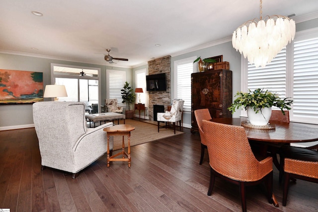 living room with dark wood-style flooring, a fireplace, visible vents, and crown molding