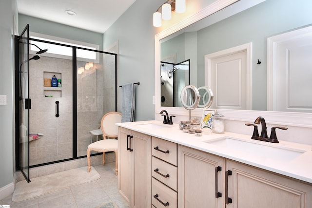 full bath with tile patterned flooring, a sink, a shower stall, and double vanity