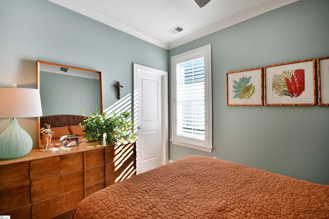 bedroom featuring visible vents and crown molding