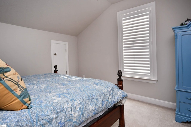 bedroom with light carpet, baseboards, and lofted ceiling