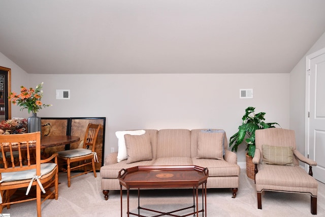 living room with light carpet, vaulted ceiling, and visible vents