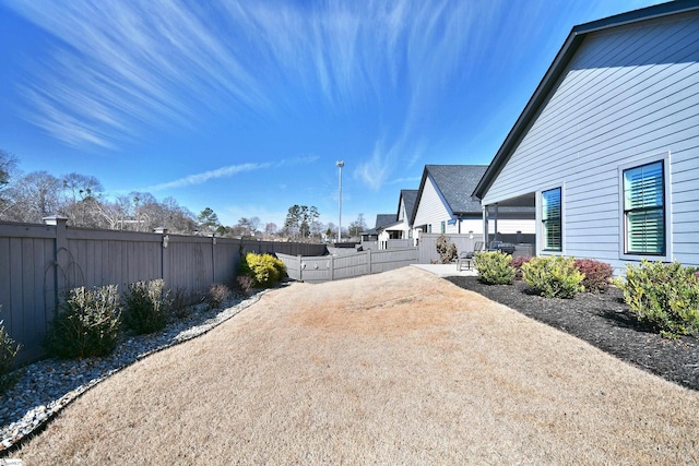 view of yard with a patio area and a fenced backyard