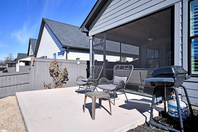 view of patio / terrace with a grill and fence