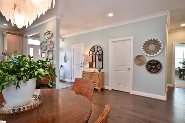 dining area featuring baseboards, dark wood-type flooring, and crown molding