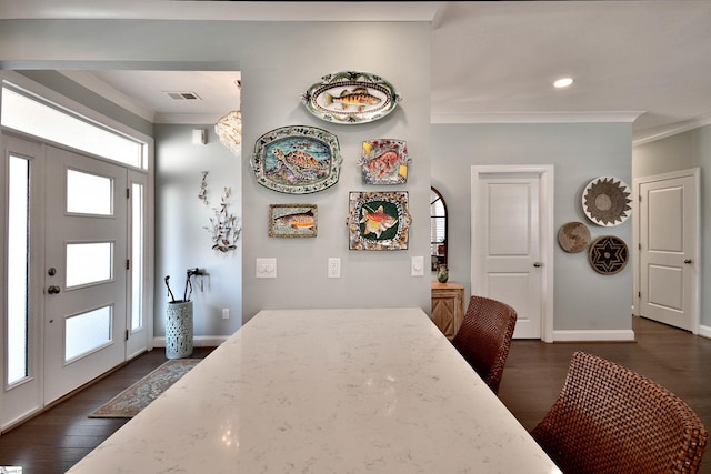 dining area with ornamental molding, visible vents, dark wood finished floors, and baseboards