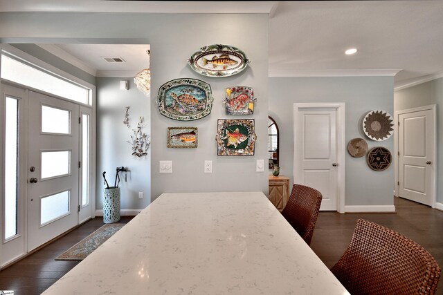 dining area with ornamental molding, visible vents, dark wood finished floors, and baseboards