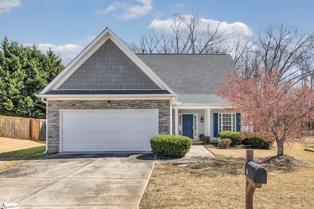 view of front of home with an attached garage, stone siding, fence, and concrete driveway