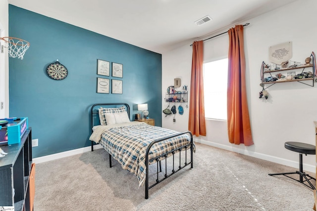 carpeted bedroom featuring baseboards and visible vents