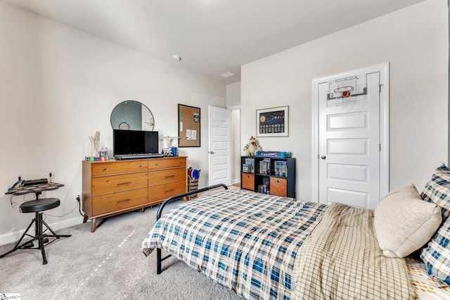 bedroom with baseboards and light colored carpet