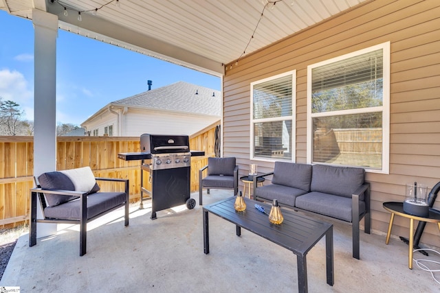 view of patio featuring fence, an outdoor living space, and area for grilling