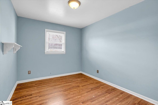 unfurnished room featuring light wood-type flooring and baseboards