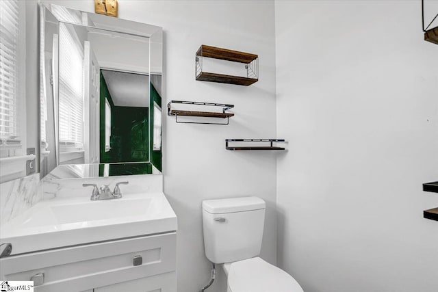 bathroom with toilet and vanity